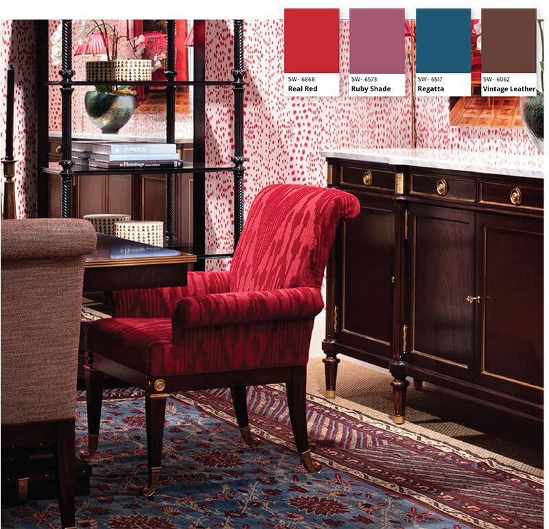 bright red dining room that is balanced with a darker rug and brown accents 
